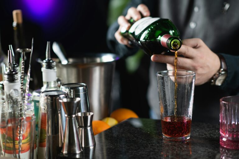 Bartender Pours Sweet Red Vermouth for Negroni Cocktail