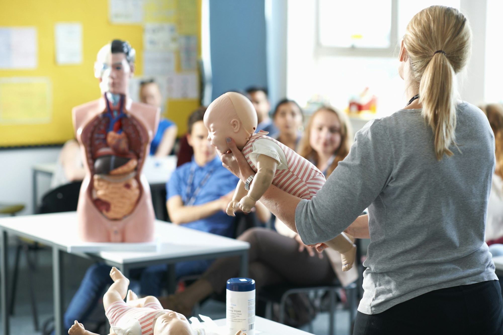 Lecturer speaking to college students in Childcare class