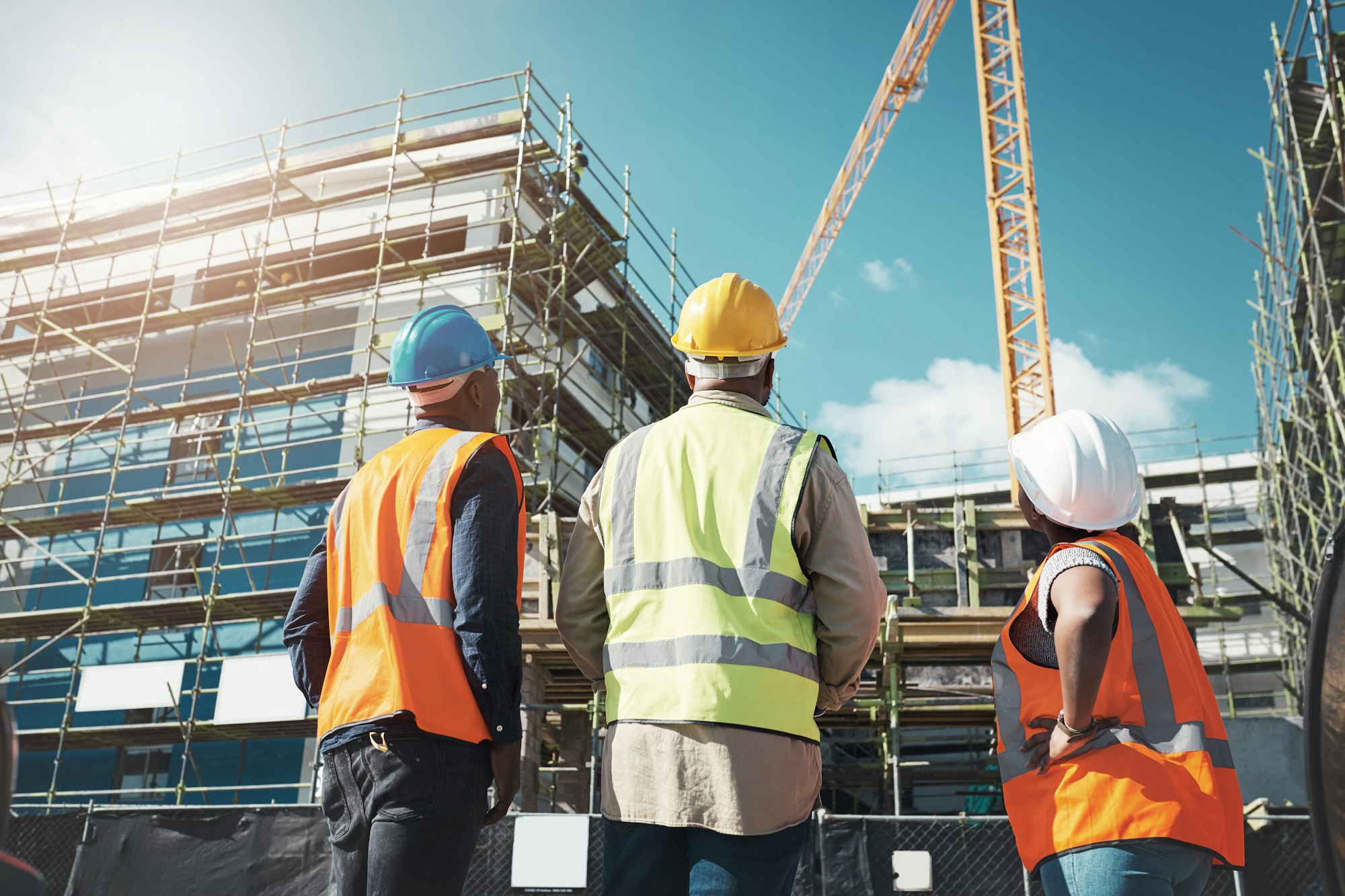 Shot of a group of builders assessing progress at a construction site